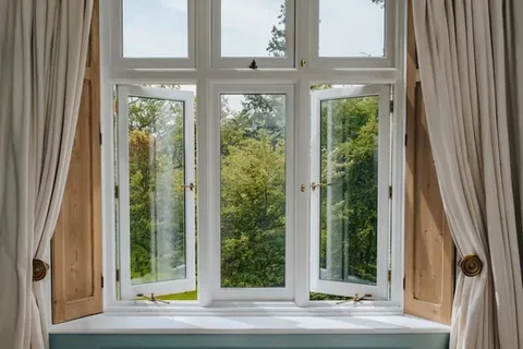 White casement replacement windows cranked open for maximum airflow in a Central Ohio home
