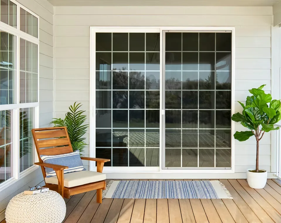 White vinyl sliding patio door with grid pattern installed on a back porch by a top window company in Columbus, Ohio